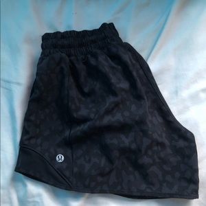 Size 4 black Lululemon shorts with light design. No rips. Like new